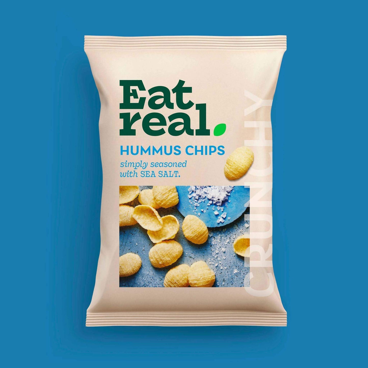 Pack of Eat Real 110g sea salt hummus chips on a blue background