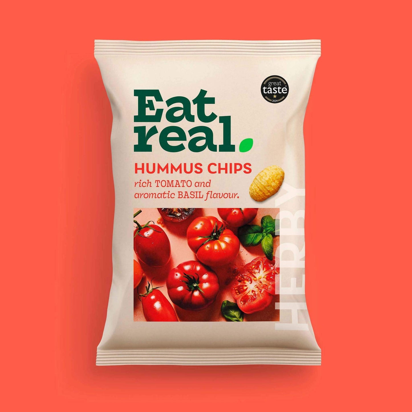 Pack of Eat Real 45g hummus chips with tomato and basil flavour on a red background