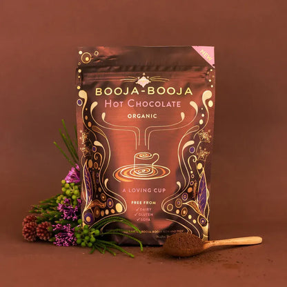Booja Booja Hot Chocolate Organic packaging with rich cocoa and flowers on brown background.