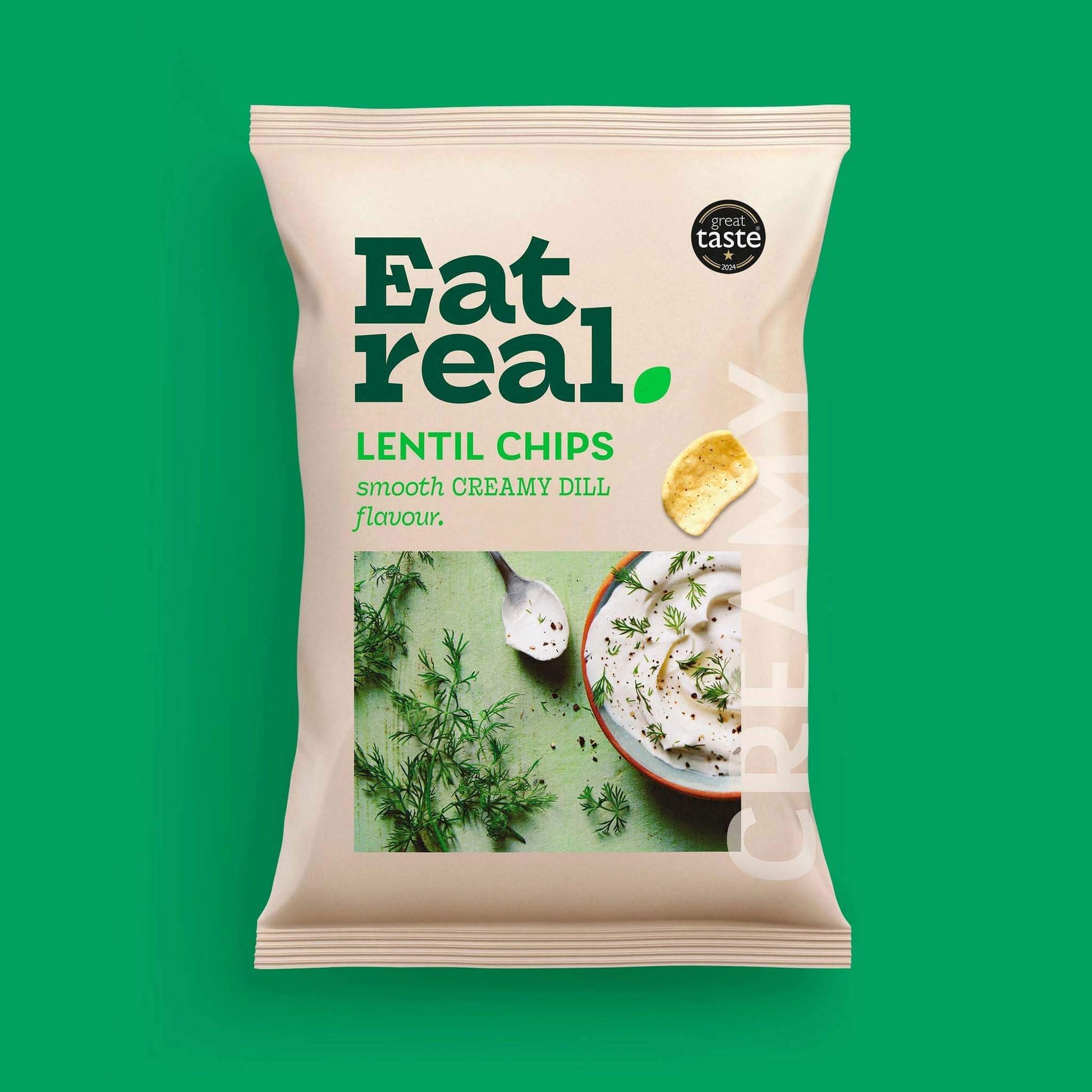 Pack of Eat Real 40g creamy dill flavour lentil chips on a green background