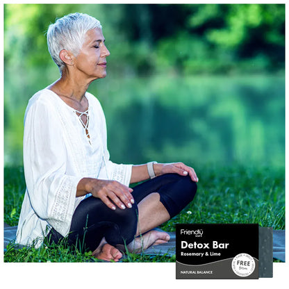 Woman sitting outdoors with a 'Detox Bar' product in the foreground