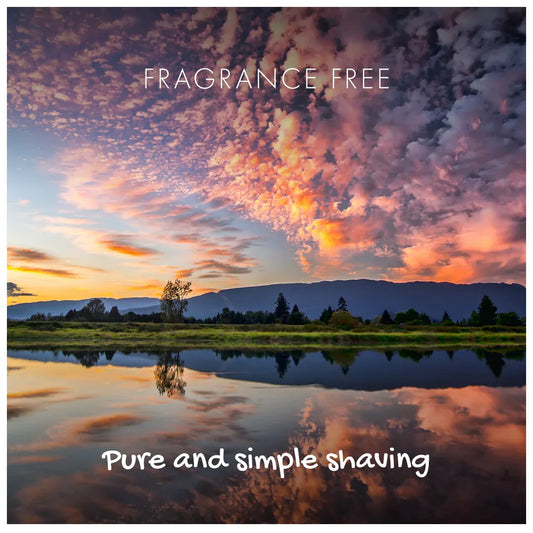 Scenic landscape with a lake and mountains, featuring 'Fragrance Free' and 'Pure and simple shaving' text.
