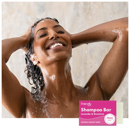 Woman showering with a Friendly Shampoo Bar in the foreground