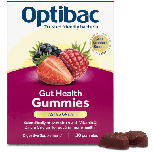 Optibac Gut Health Gummies packaging box with illustrations of strawberries, raspberries, and blueberries, plus three chocolate gummies shown in front on a white background.