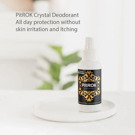 PitROK 100ml fragrance free Crystal Deodorant spray bottle on a white surface with a blurred background.