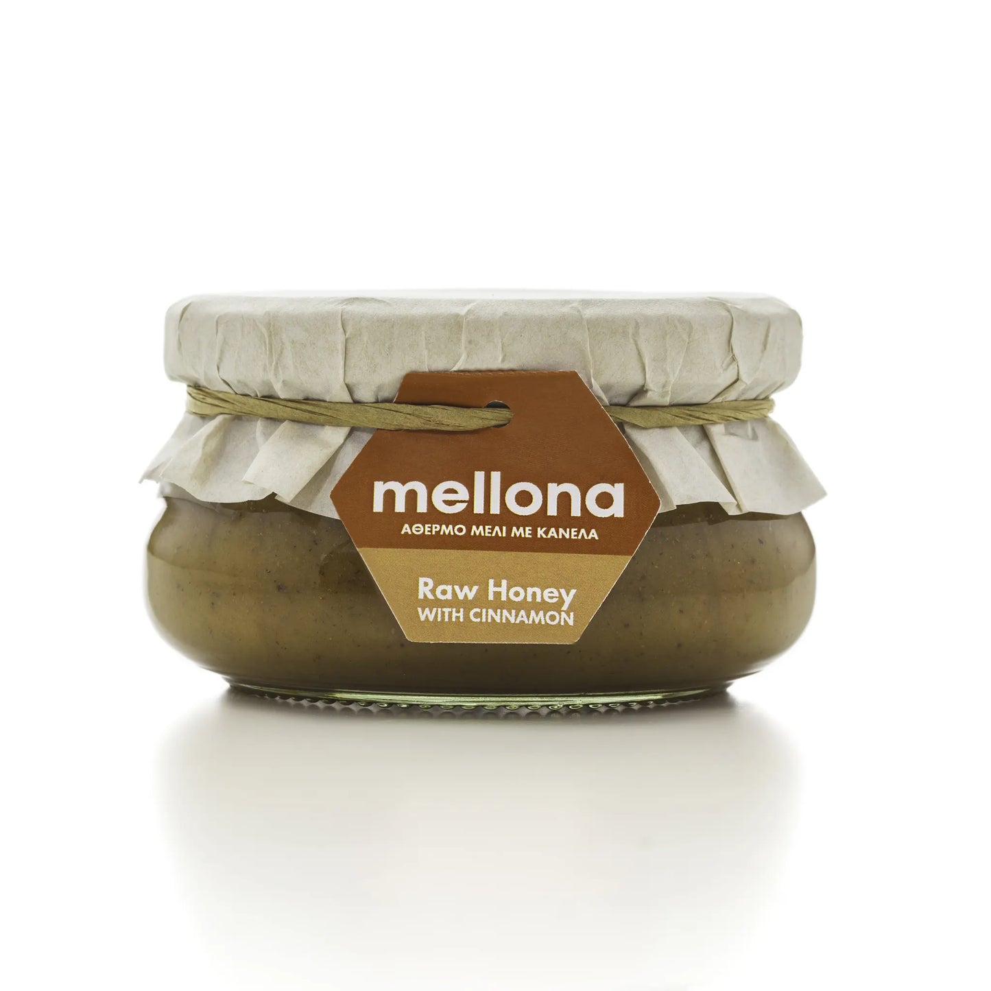 Mellona Raw Honey with Cinnamon in a glass jar, featuring a tag highlighting its pure ingredients from Cyprus.
