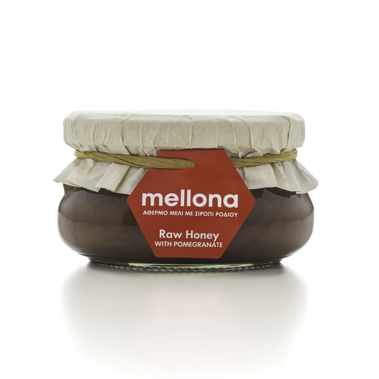 Mellona Raw Honey with Pomegranate in a jar featuring a decorative label and natural packaging.