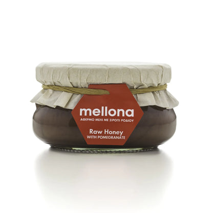 Mellona Raw Honey with Pomegranate in a jar featuring a decorative label and natural packaging.