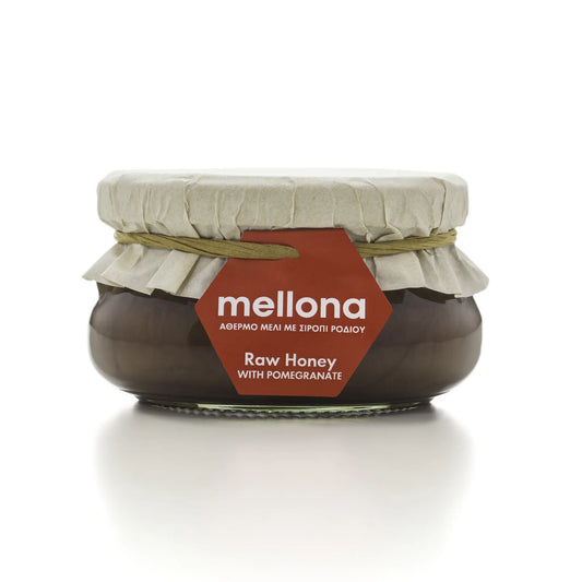 Mellona Raw Honey with Pomegranate in a jar featuring a decorative label and natural packaging.