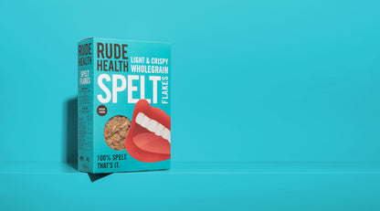 Rude Health Spelt Flakes lifestyle shot, bowl with milk