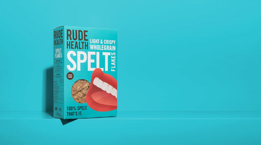 Rude Health Spelt Flakes lifestyle shot, bowl with milk